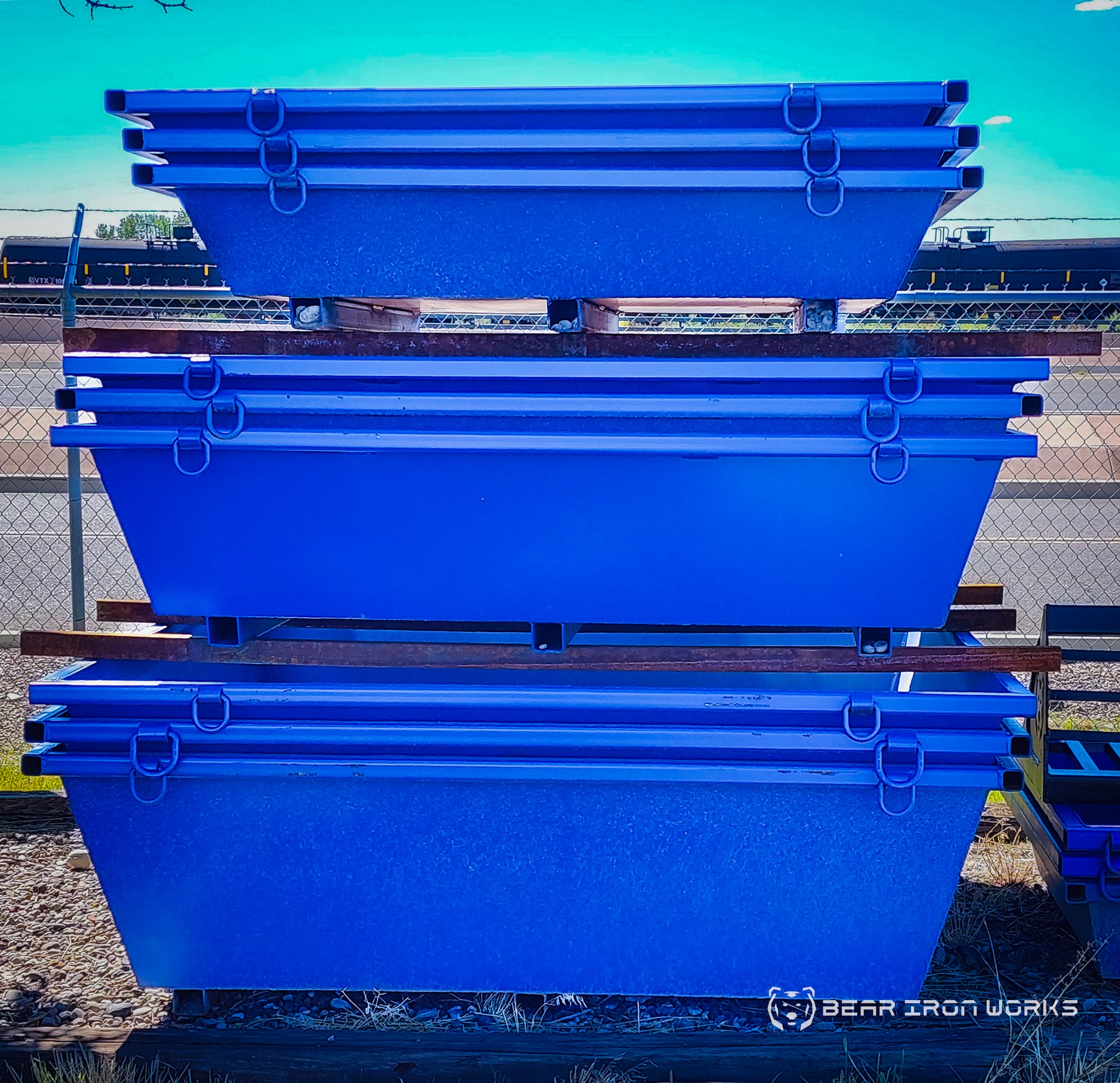 Concrete washout tubs stacked together ready for use by a concrete washout service.